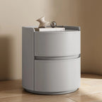 Moderní kulatý noční stolek s koženou odkládací plochou a 2 zásuvkami